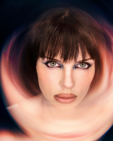 Close up portrait of Julia Fox with abstract light shape in front of her face.